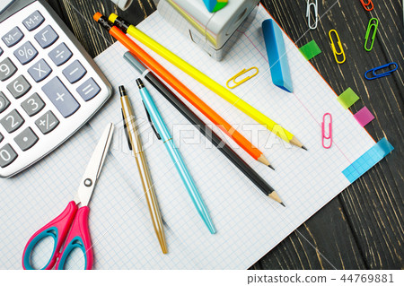 Stationery on the background of a wooden table, top view Stationery on the background of a wooden table, top view 44769881
