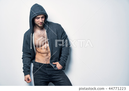 Brutal naked muscular man dressed in a grey hoodie 44771223