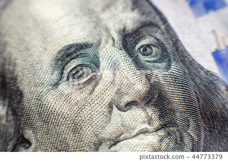 Benjamin Franklin face on us one hundred dollar bill macro isolated, united states money closeup 44773379