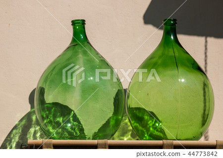 Empty big bulbous bottles in the sunshine 44773842