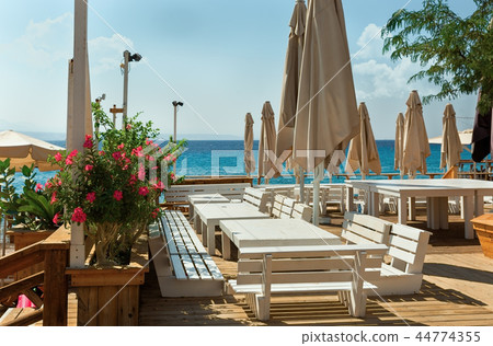 tables and benches against the sea 44774355