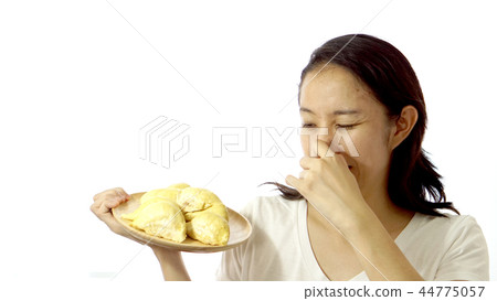 Asian girl smelling stinky durian. Smelly fruit Asian girl smelling stinky durian. Smelly fruit 44775057