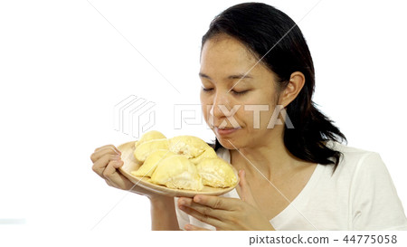 Asian girl smelling stinky durian. Smelly fruit Asian girl smelling stinky durian. Smelly fruit 44775058