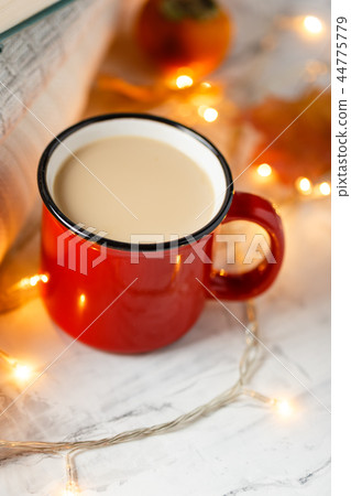 Autumn light still life with coffee and book 44775779