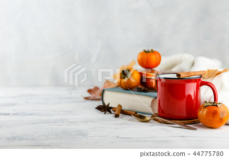 Autumn light still life with coffee and book 44775780