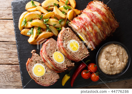 Freshly cooked meat loaf with egg wrapped in bacon Freshly cooked meat loaf with egg wrapped in bacon 44776286