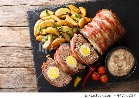Delicious sliced meat loaf wrapped in bacon 44776287