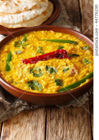 Dal Tadka yellow lentil Indian soup with bread 44776290