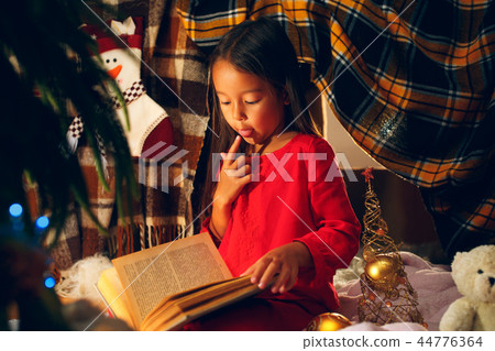 happy girl reading a book in the winter happy girl reading a book in the winter 44776364