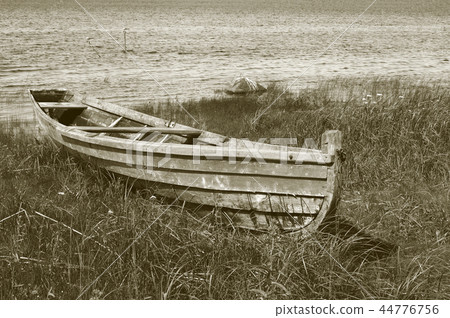 Old wooden boat on the lake bank Old wooden boat on the lake bank 44776756