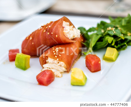 rolls of tuna with crab meat on the plate 44777406