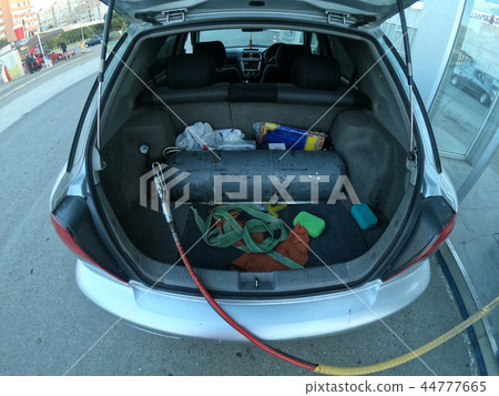Filling the car with methane gas bottle in the trunk 44777665