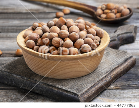 hazelnut nuts in a brown wooden bowl hazelnut nuts in a brown wooden bowl 44777862