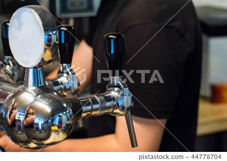 Chrome beer taps in modern bar close Chrome beer taps in modern bar close 44778704