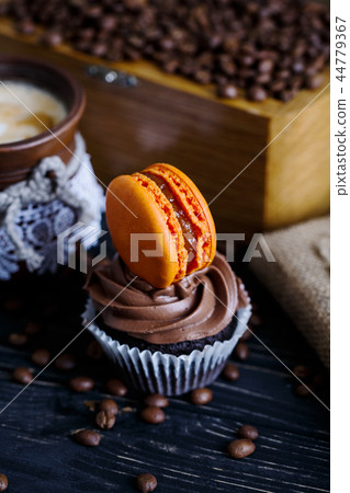 Chocolate cake with sweet hamburger. Cake on a wooden table Chocolate cake with sweet hamburger. Cake on a wooden table 44779367