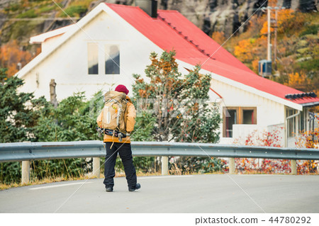 Traveler walking along the road.  44780292