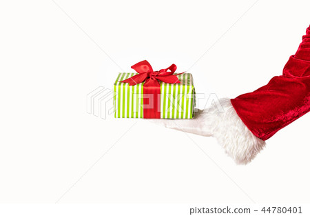 Santas hand holding a giftbox with red bow Santas hand holding a giftbox with red bow 44780401