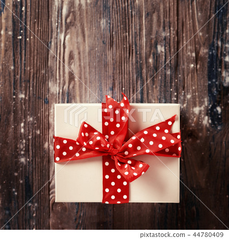 Top view of Christmas gift with big red bow 44780409