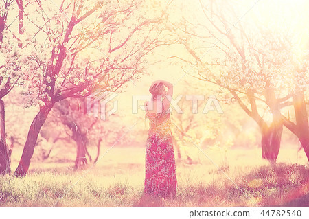 spring girl apple flowers, nature portrait of happy girl with long hair in blooming apple trees, freedom purity concept of happiness 44782540