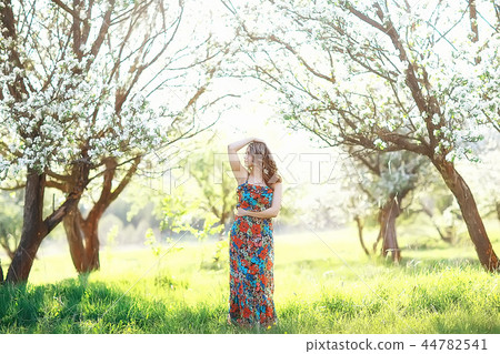 girl spring / portrait of a beautiful girl in a spring blooming park, apple blossoms, beauty, cleanliness, freshness, the smell of spring 44782541