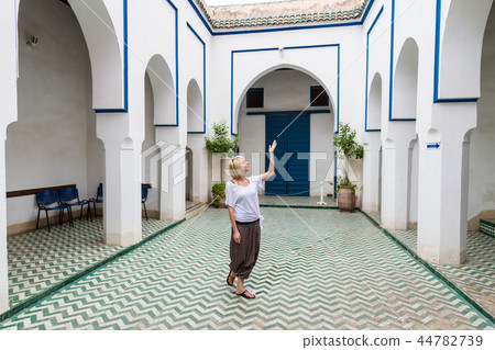 Woman admiring traditional moroccan architecture in one of the palaces in medina of Marrakesh Woman admiring traditional moroccan architecture in one of the palaces in medina of Marrakesh 44782739
