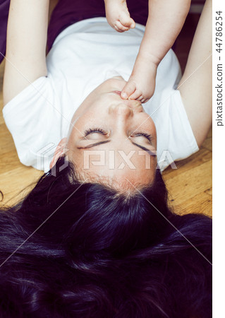 young brunette happy mother holding toddler baby son, breast-fee 44786254