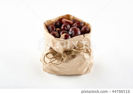Chestnuts in paper bag on white background Chestnuts in paper bag on white background 44786518