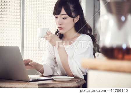 A woman at a cafe A woman at a cafe 44789140
