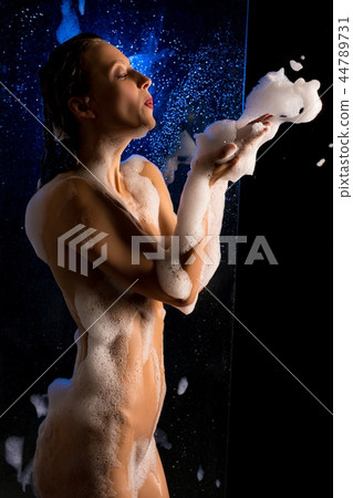 Slim nude girl rubbed with soap in the dark view 44789731