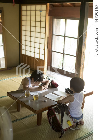 Boy doing homework on summer vacation 44790167