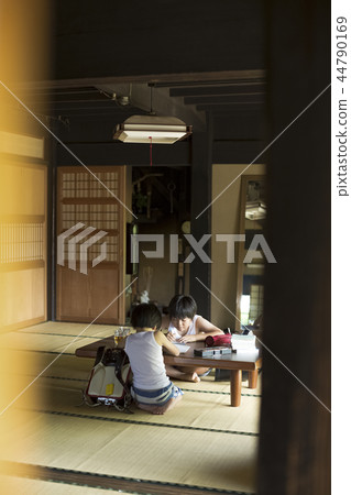 Boy doing homework on summer vacation 44790169