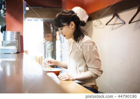 A woman who enjoys ramen alone 44790190