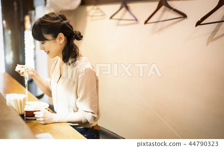A woman who enjoys ramen alone 44790323