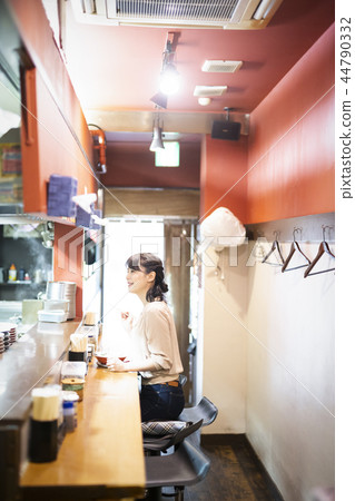 A woman who enjoys ramen alone 44790332