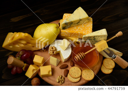 Various types of cheese on a rustic wooden table Various types of cheese on a rustic wooden table 44791739