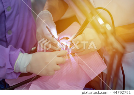 doctor cleaning teeth patient with ultrasonic tool doctor cleaning teeth patient with ultrasonic tool 44792791