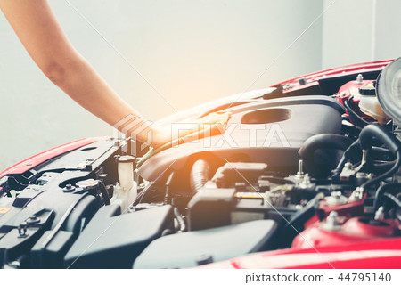 Woman wiping car engine for new vehicle 44795140