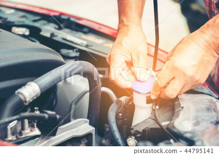 Hand of auto mechanic with a wrench 44795141