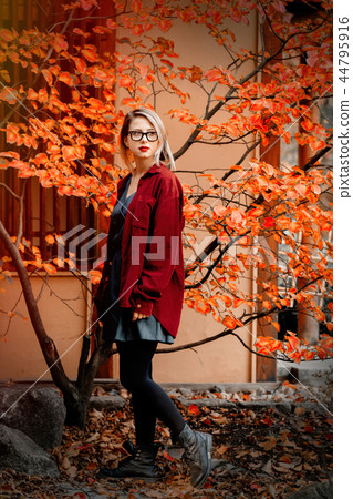 Beautiful girl in red shirt in a park Beautiful girl in red shirt in a park 44795916