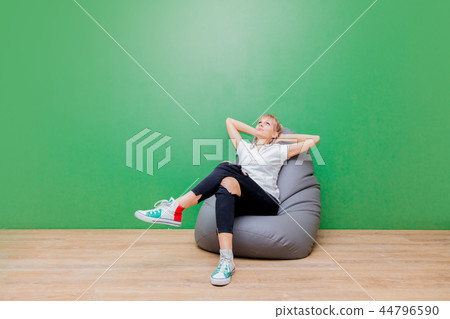 woman resting in a chair after moving to a new apartment 44796590
