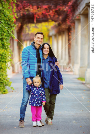 father, mother and daughter in a park father, mother and daughter in a park 44796788
