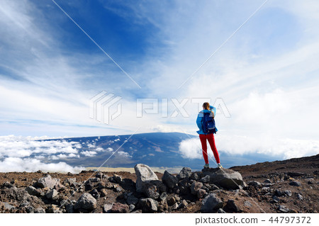 Tourist admiring view of Mauna Loa volcano Tourist admiring view of Mauna Loa volcano 44797372