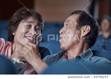 Spectators watching a movie in a cinema Spectators watching a movie in a cinema 44799247