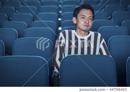 Spectators watching a movie in a cinema Spectators watching a movie in a cinema 44799403