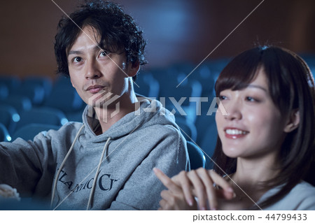Spectators watching a movie in a cinema Spectators watching a movie in a cinema 44799433