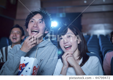 Spectators watching a movie in a cinema Spectators watching a movie in a cinema 44799472