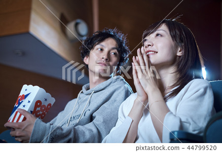 Spectators watching a movie in a cinema 44799520