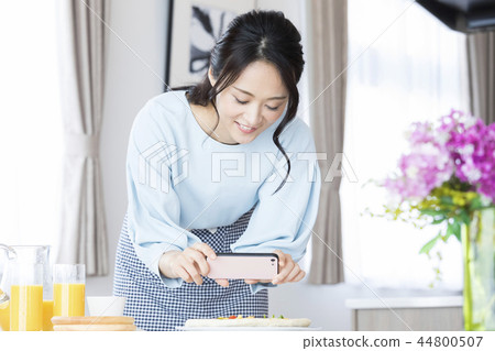 A woman shooting a dish A woman shooting a dish 44800507