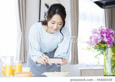 A woman shooting a dish A woman shooting a dish 44800509