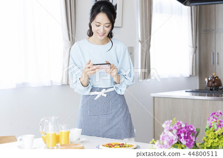 A woman shooting a dish 44800511